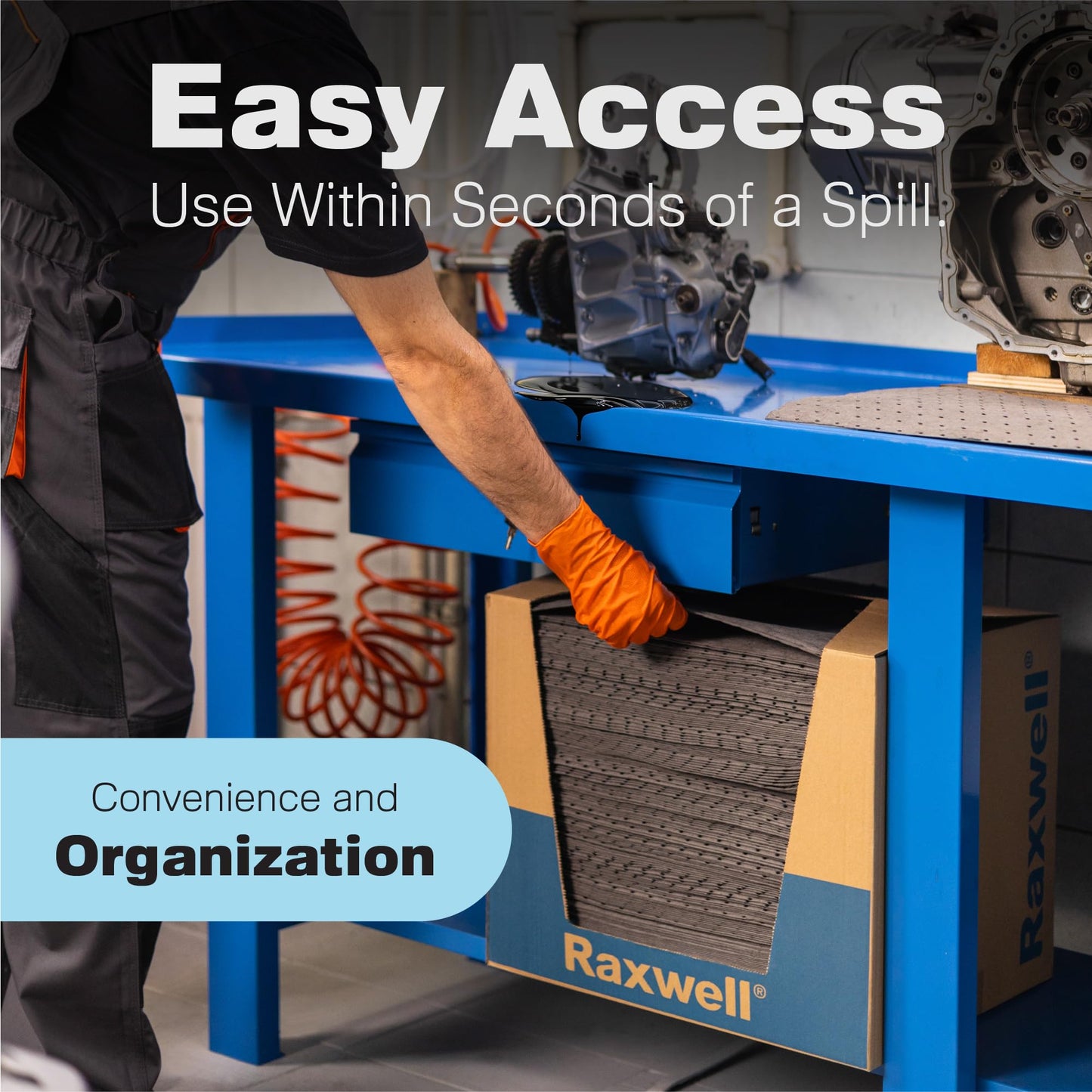 A person wearing an orange glove pulls an absorbent pad from a Raxwell box under a blue workbench in a workshop. The image highlights easy access, convenience, and organization.