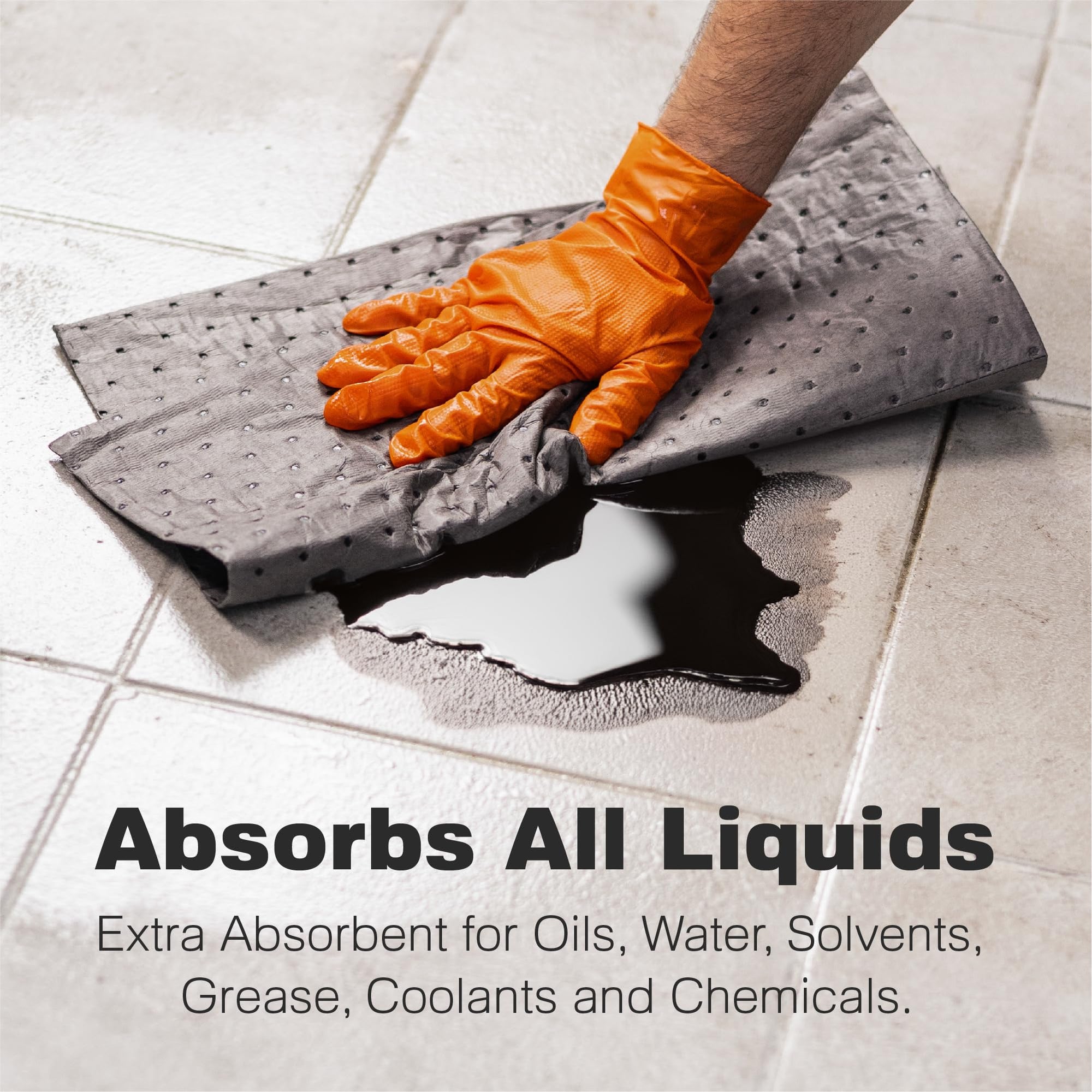 A gloved hand uses an absorbent pad to soak up a dark liquid spill on a tiled floor. The text reads: Absorbs All Liquids. Extra absorbent for oils, water, solvents, grease, coolants and chemicals.