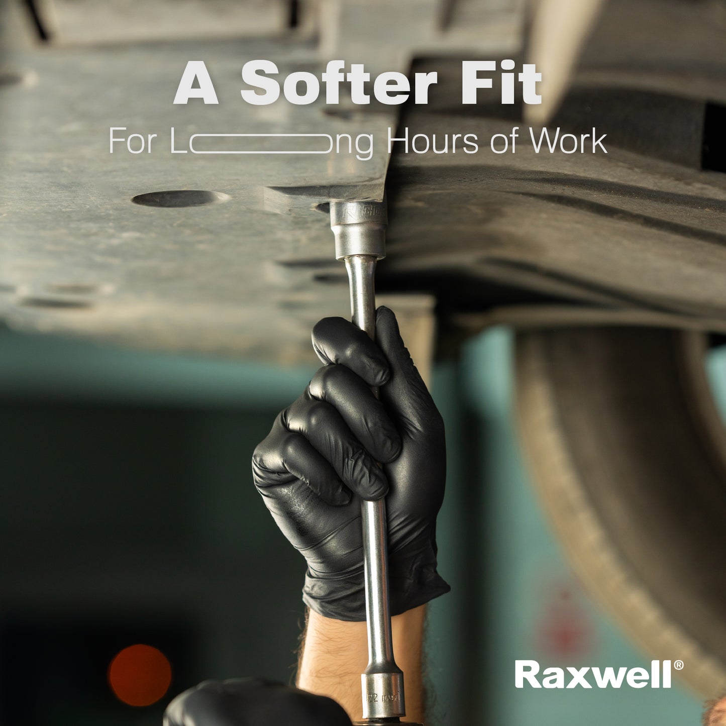 Auto mechanic uses a ratchet while wearing black Raxwell gloves under banner “A Softer Fit for Long Hours of Work.” Demonstrates long-wear comfort.